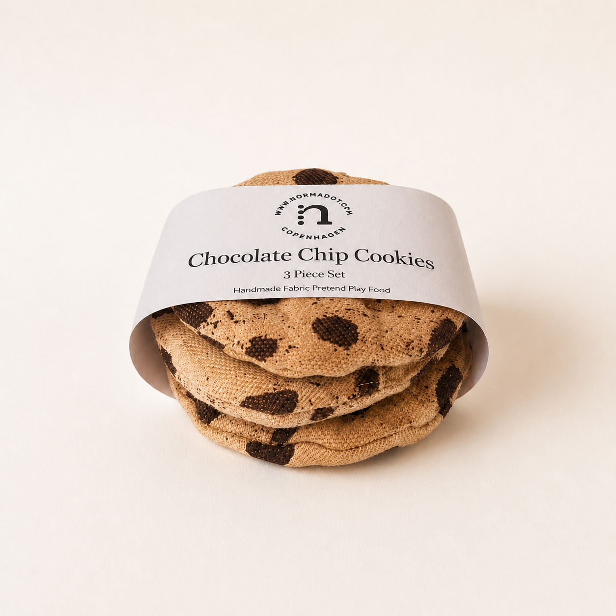Handmade fabric chocolate chip cookies wrapped with a paper band, shown as a 3 piece pretend play food set.