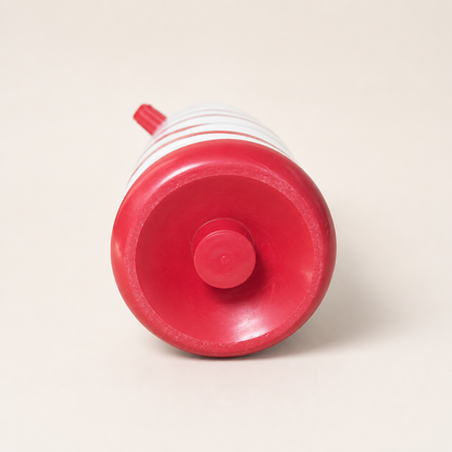 Bottom view of a vintage red and white striped thermos flask showing the red base and signs of age and use.