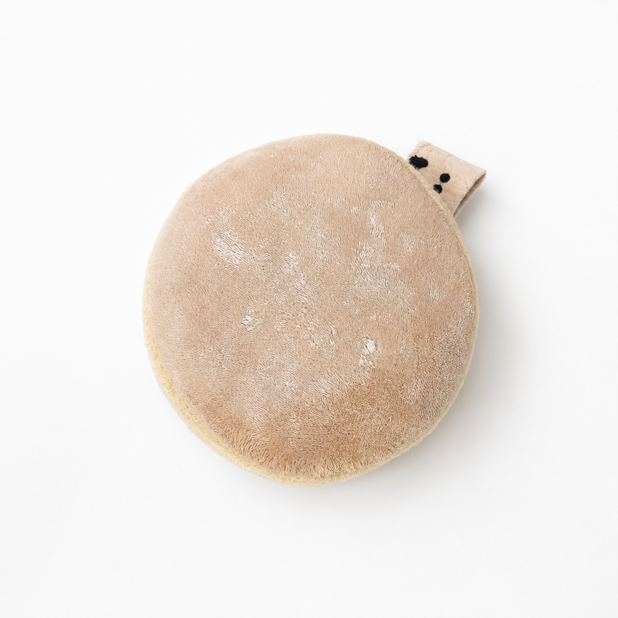 Top view of a handmade Berliner Pfannkuchen velvet play food toy with powdered sugar details and fabric label
