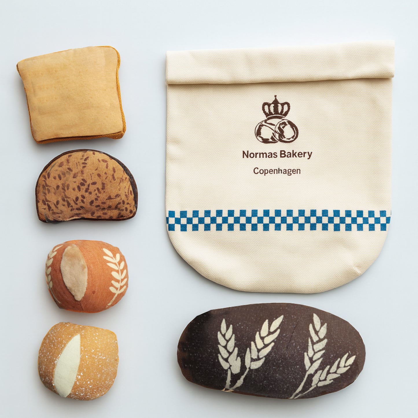 Bread slices and a Normas Bakery bag on a light background