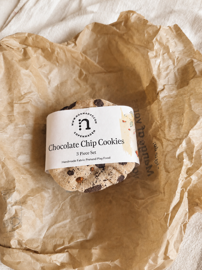 Set of fabric play food chocolate chip cookies in packaging with a label on crumpled brown paper.