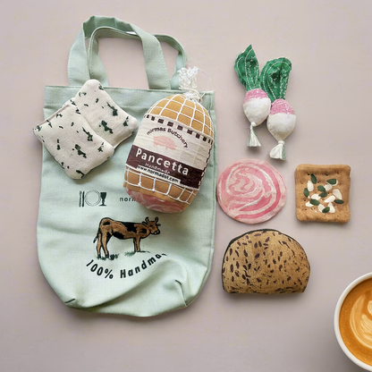 Light green tote bag with food-themed items on a neutral background
